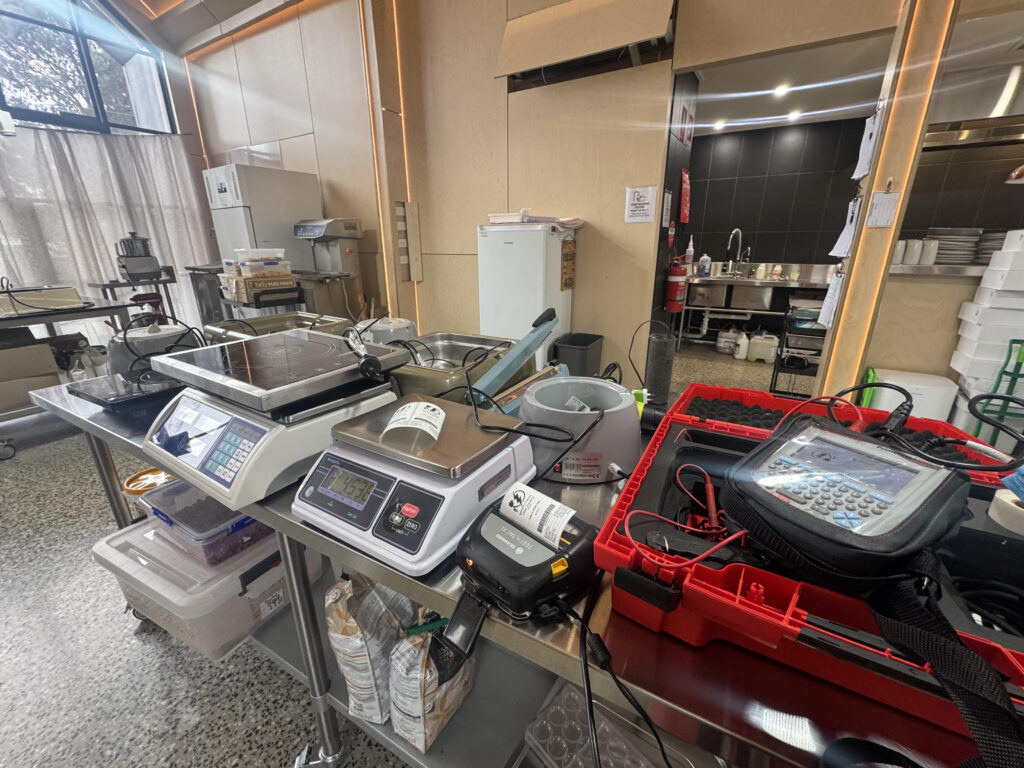 Technician performing electrical testing and tagging at Sisko Chocolate Studio in Trentham, ensuring compliance with Australian safety standards.